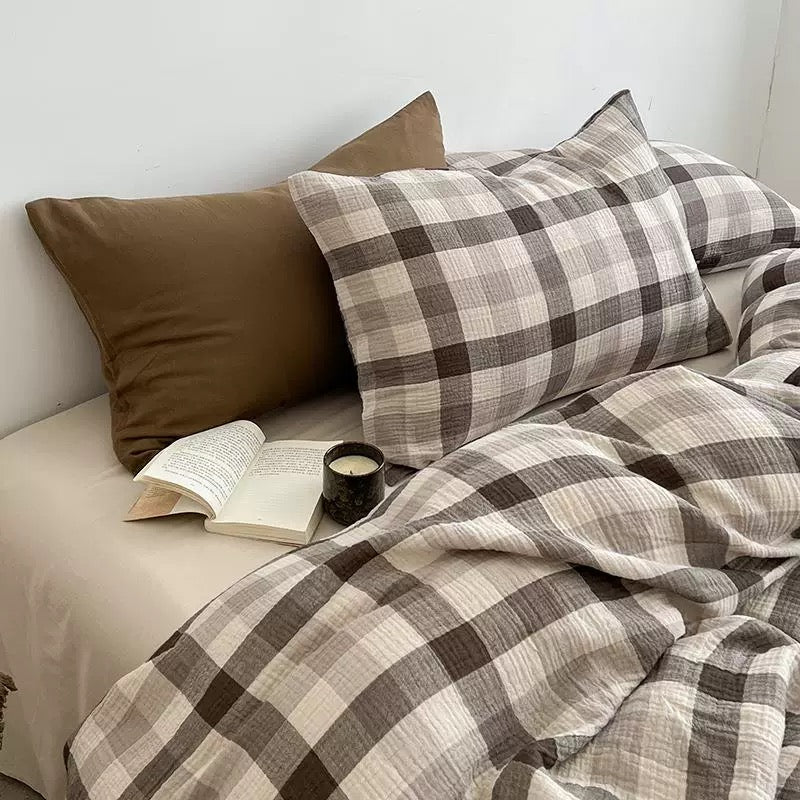 Brown-and-gray plaid duvet cover set with pillow shams and a solid brown accent pillow.
