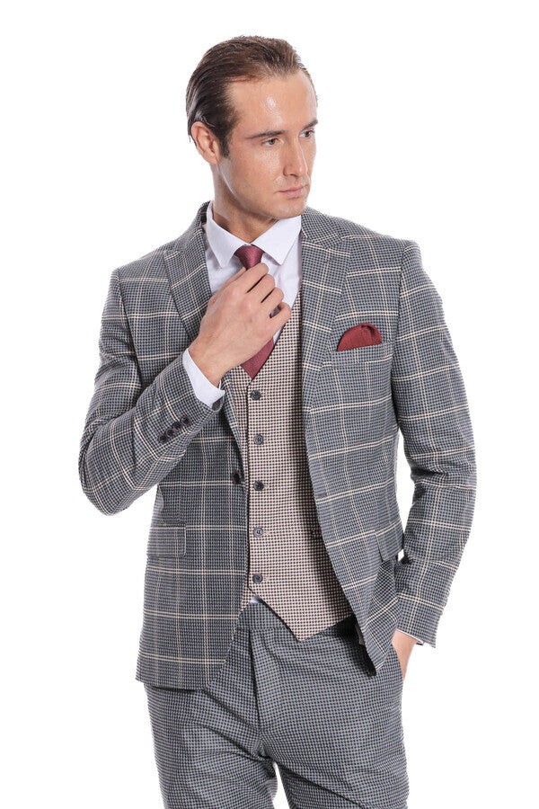 Checked grey suit with waistcoat and maroon tie, red pocket square detail