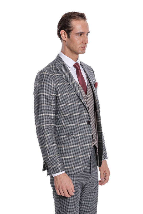 Checked grey suit with waistcoat and maroon tie, side profile