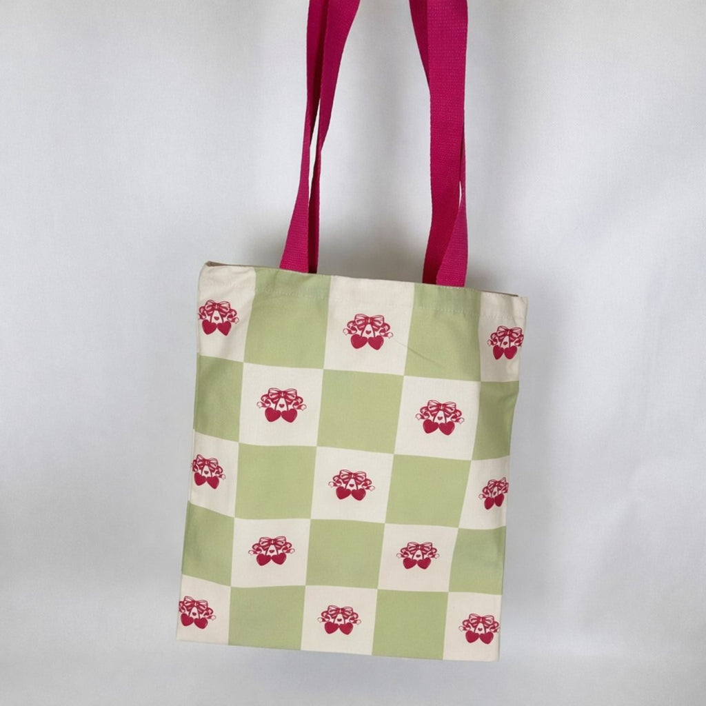 Green and cream checkered tote bag with red cherry pattern and magenta handles