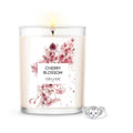 18oz cherry blossom scented candle with floral label and silver ring jewelry beside