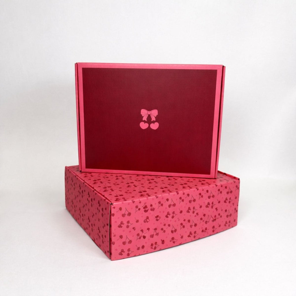 Square cherry gift box with lid open, red speckled sides and pink interior