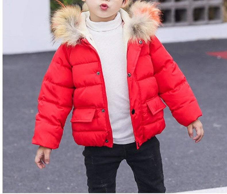 Red kids puffer jacket with faux fur hood worn with dark pants
