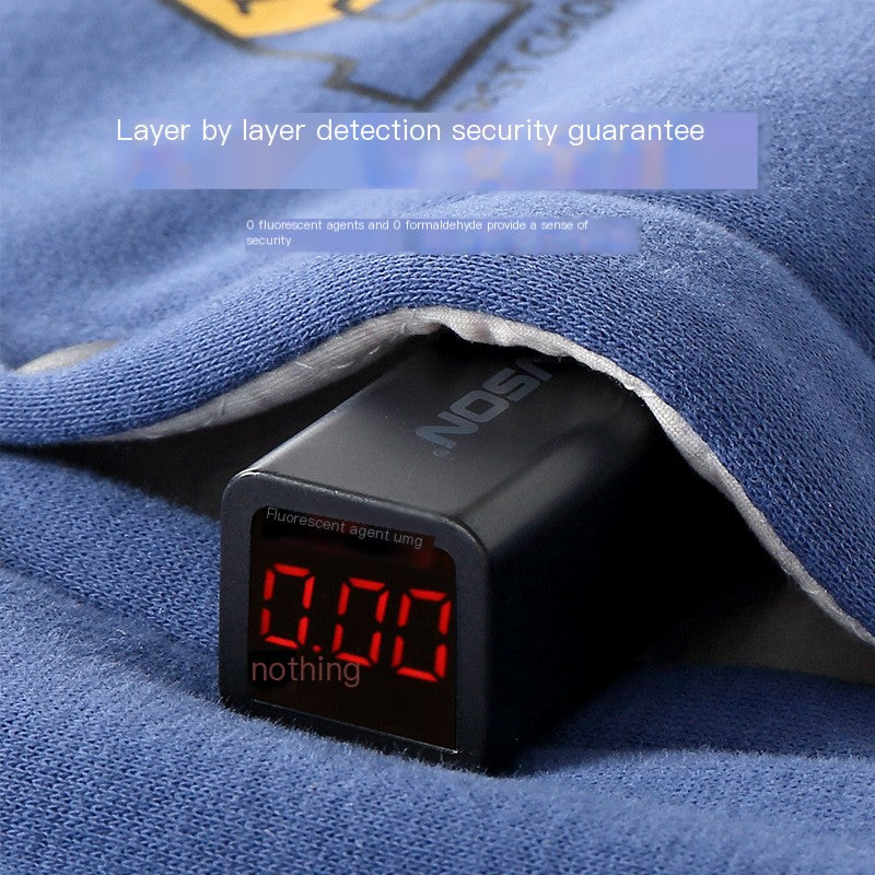 Close-up of blue cotton jacket fabric and seam with electronic security tester visible