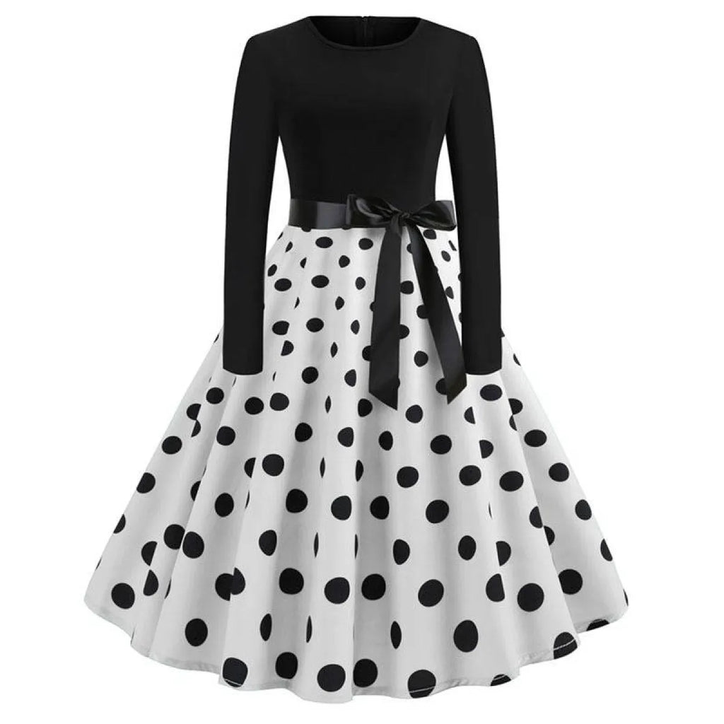 Women’s swing dress with black top, white polka-dot skirt, and black waist bow