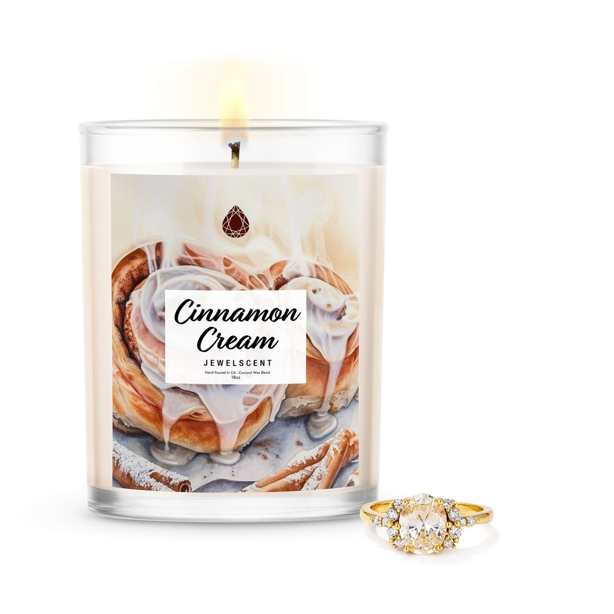 Mystery jewelry candle in clear glass, unlit wick, with ring accessory beside