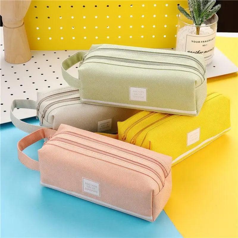Light green striped pencil pouch with carry handle, double zipper, and front label patch