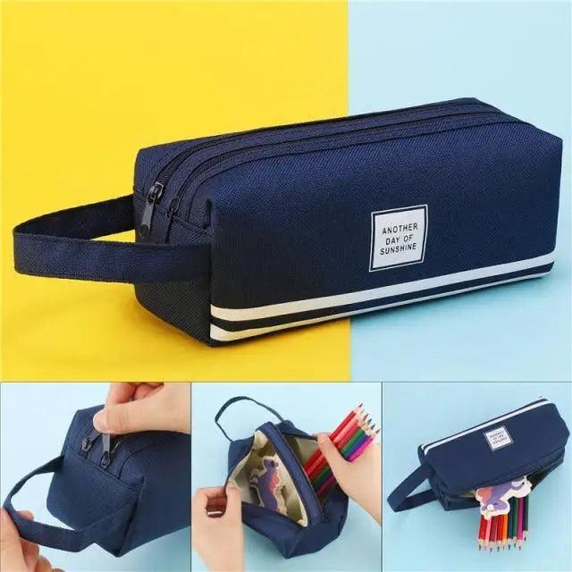 Dark blue double-zip pencil case with wrist strap and front label badge