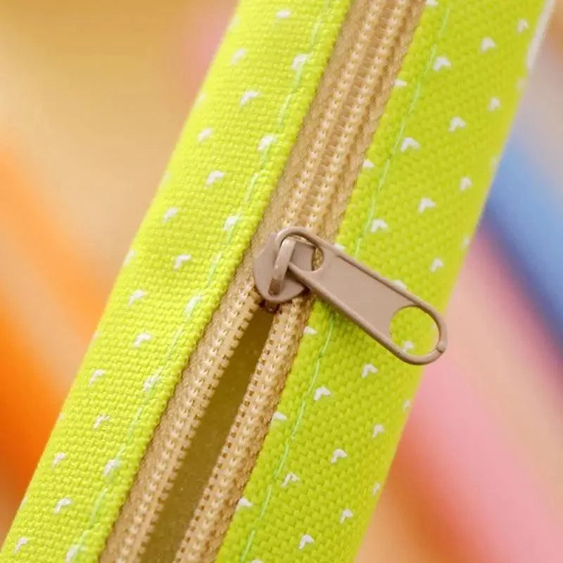 Yellow dotted canvas pencil pouch zipper with metal ring pull.