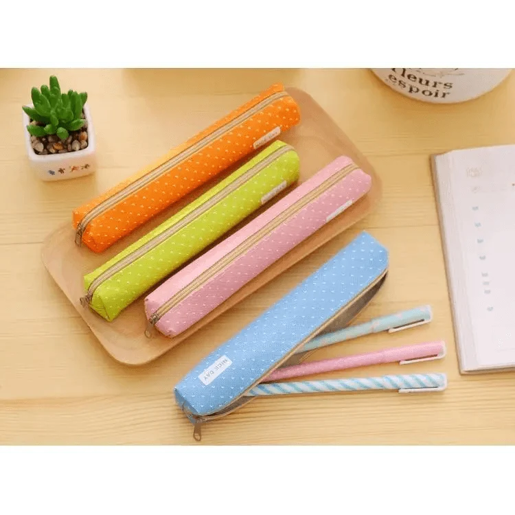 Colorful set of slim canvas pencil pouches with dotted prints and zippers.