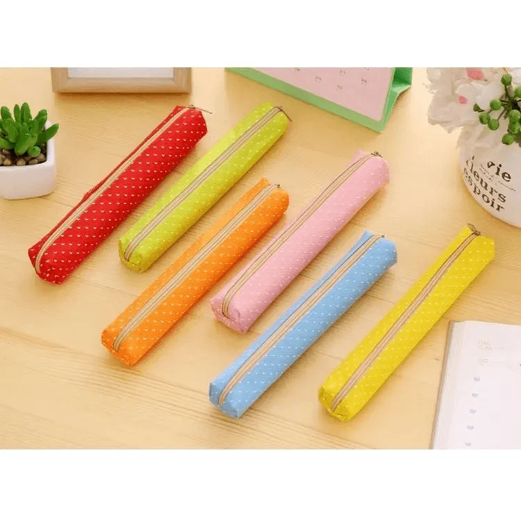 Assorted slim canvas pencil pouches with dotted prints and zipper closures.