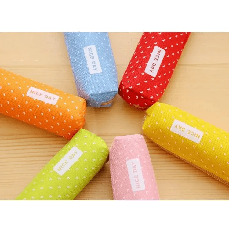 Slim canvas pencil pouches with dotted prints in assorted colors, zipper fronts.