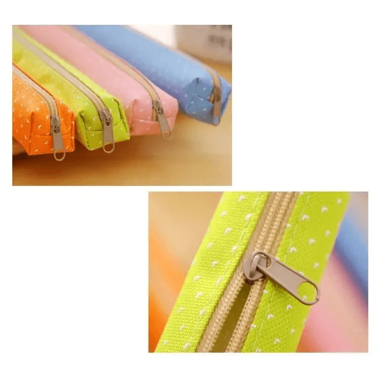 Dotted canvas pencil pouches with zipper pulls and stitched seams on display.