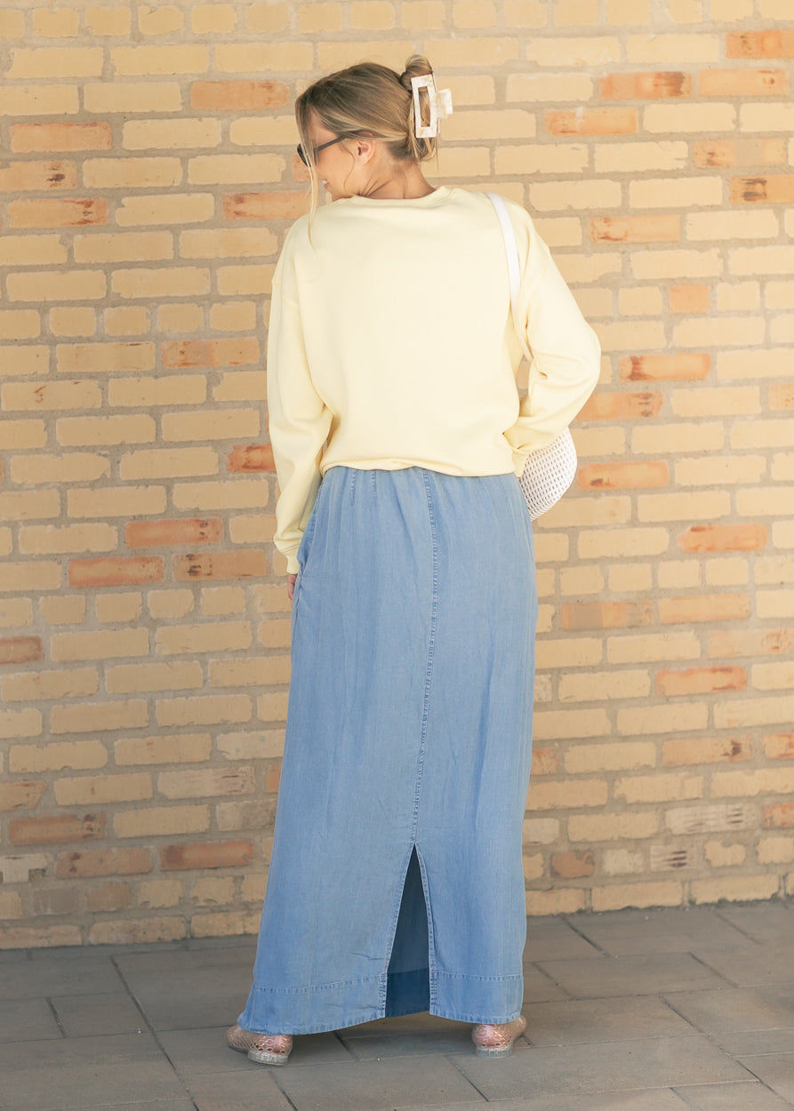Chambray maxi skirt in medium wash with front slit and gathered elastic waist