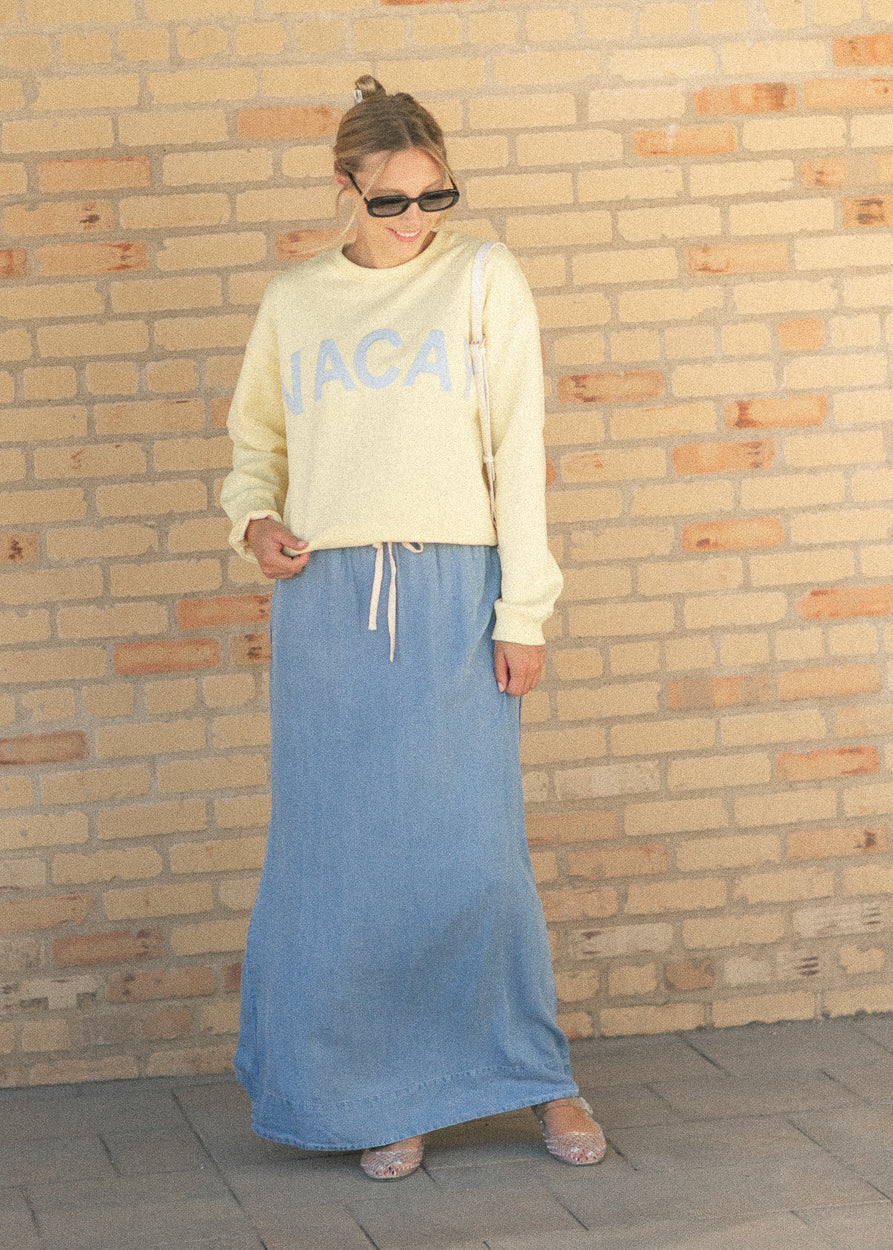 Medium wash chambray maxi skirt with elastic drawstring waistband and front slit