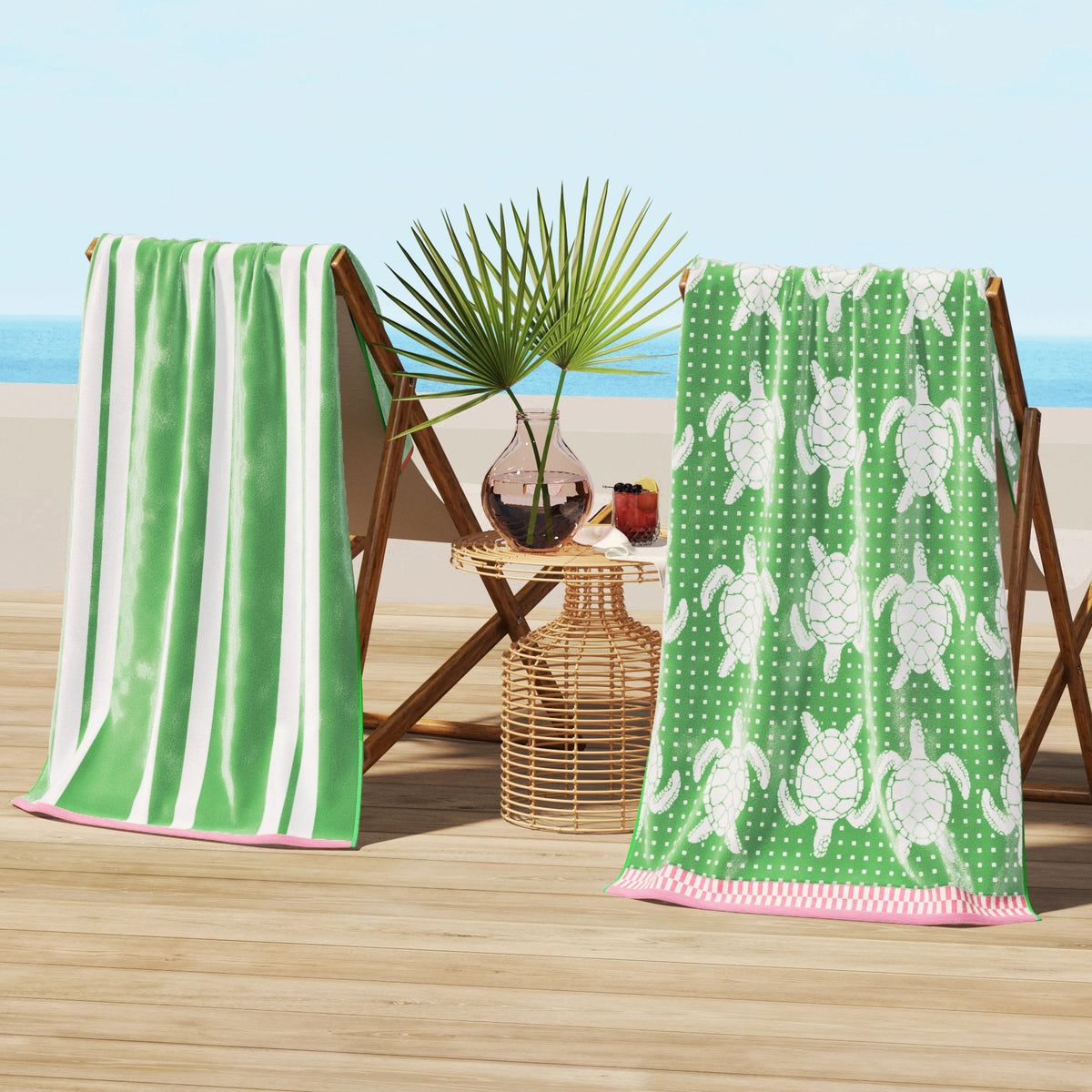 Green cotton velour beach towel with white sea turtle pattern and pink striped border