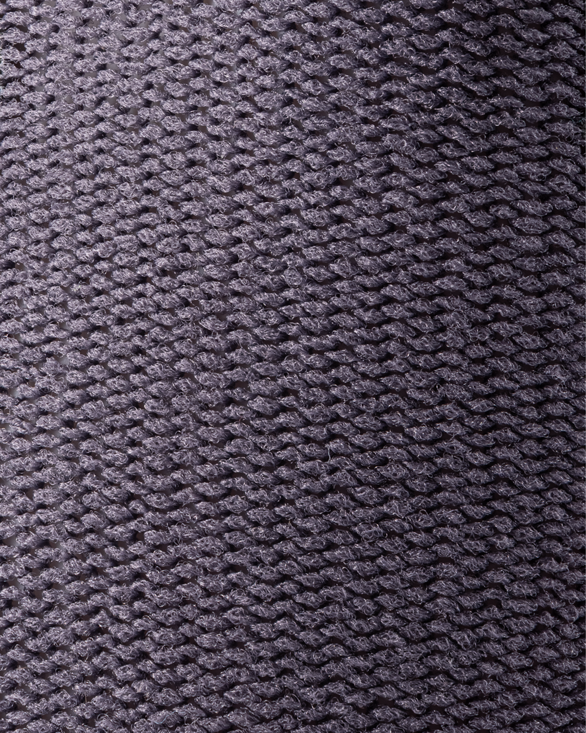 Grey knit glove material close-up texture with braided pattern