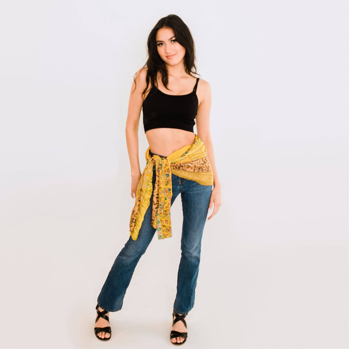 Printed patchwork scarf in golden yellow with multicolor motifs, worn as a wrap