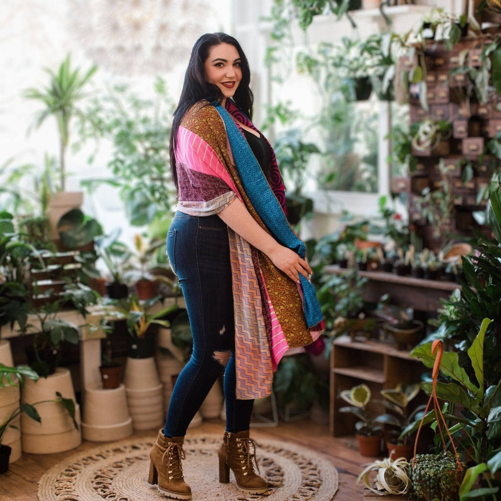 Multicolor draped scarf with teal, pink, and gold panels featuring patterned borders