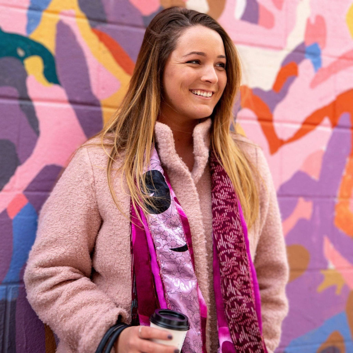 Purple and magenta scarf with intricate prints and a dark patterned trim