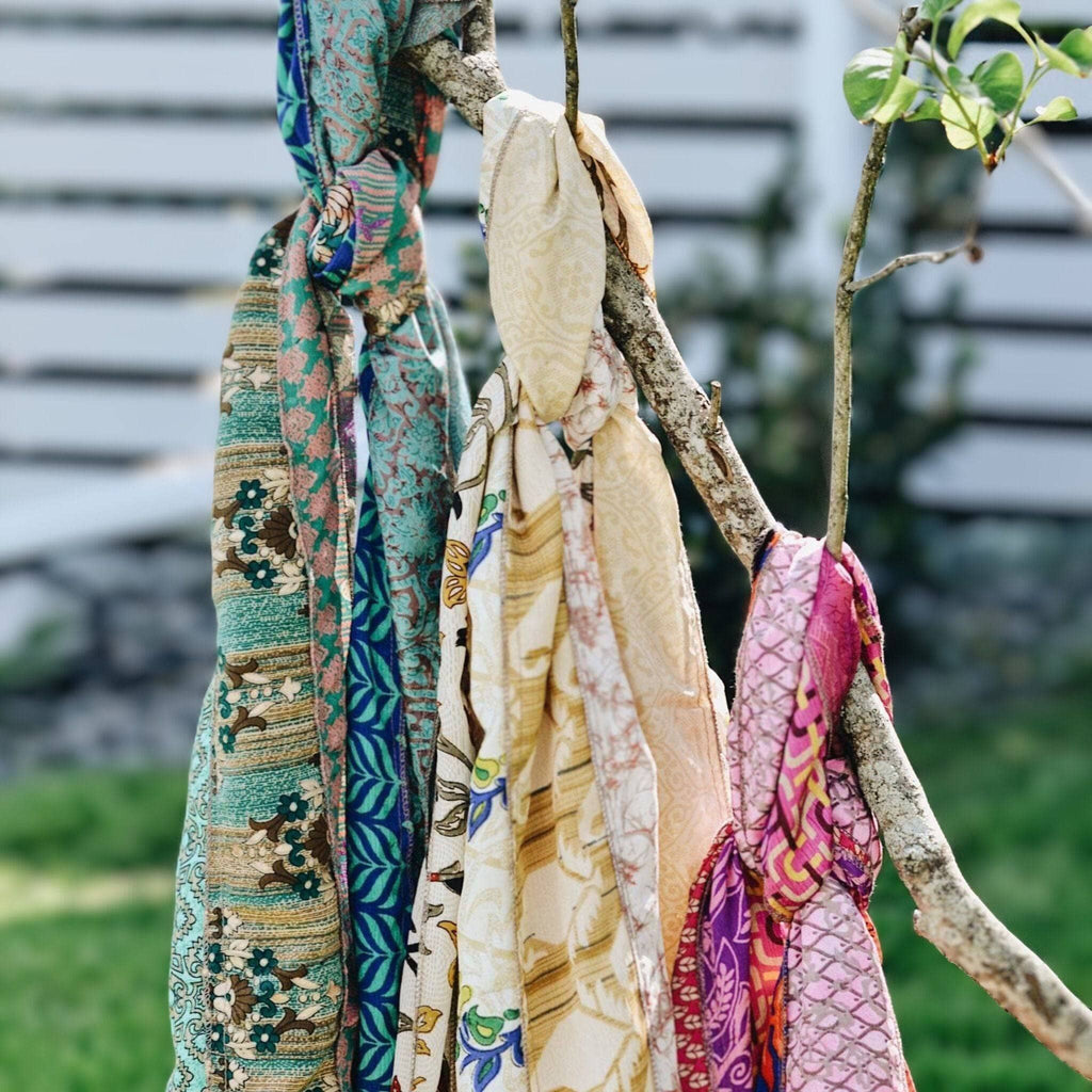 Multicolor patchwork scarf ends hanging, teal, cream, and purple floral prints