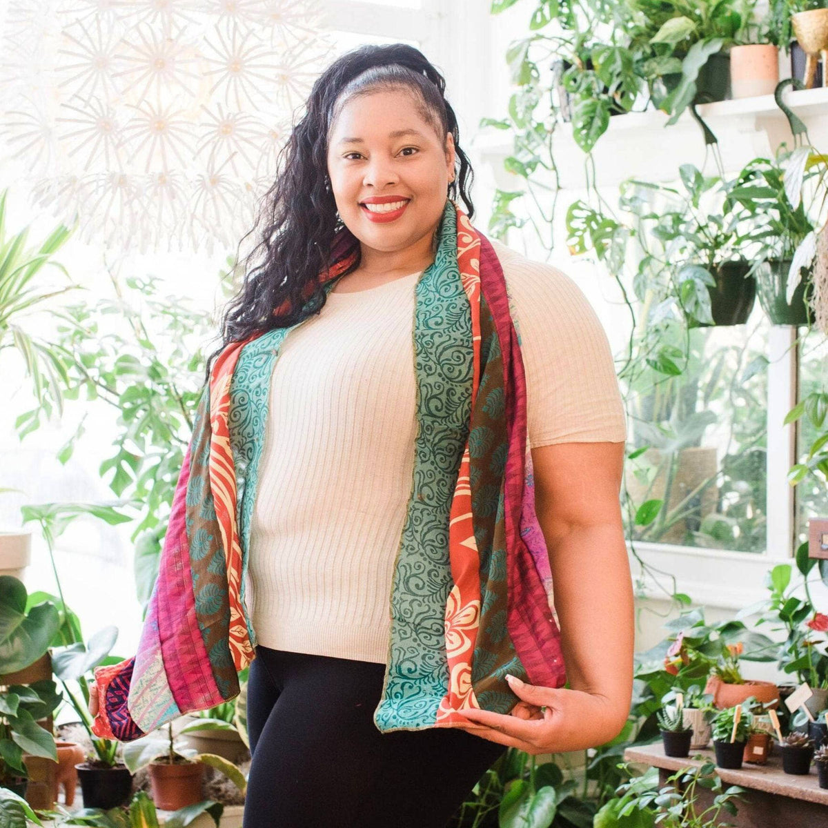 Multicolor scarf with teal, red, and green scroll patterns, draped on shoulders