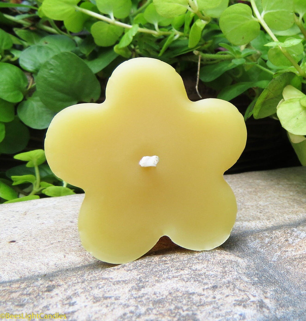 Unlit clover-shaped yellow beeswax candle