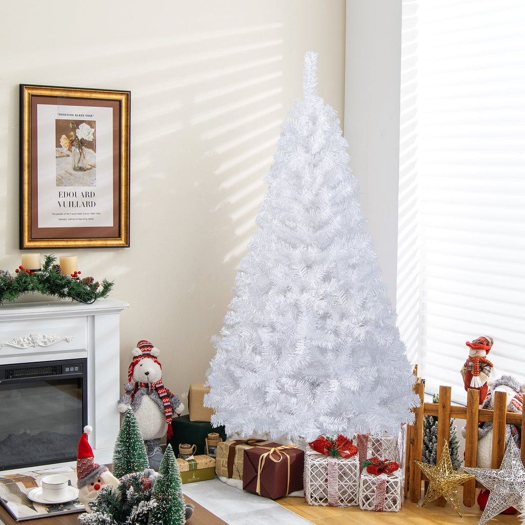 White artificial PVC Christmas tree with stand, in living room with wrapped gifts