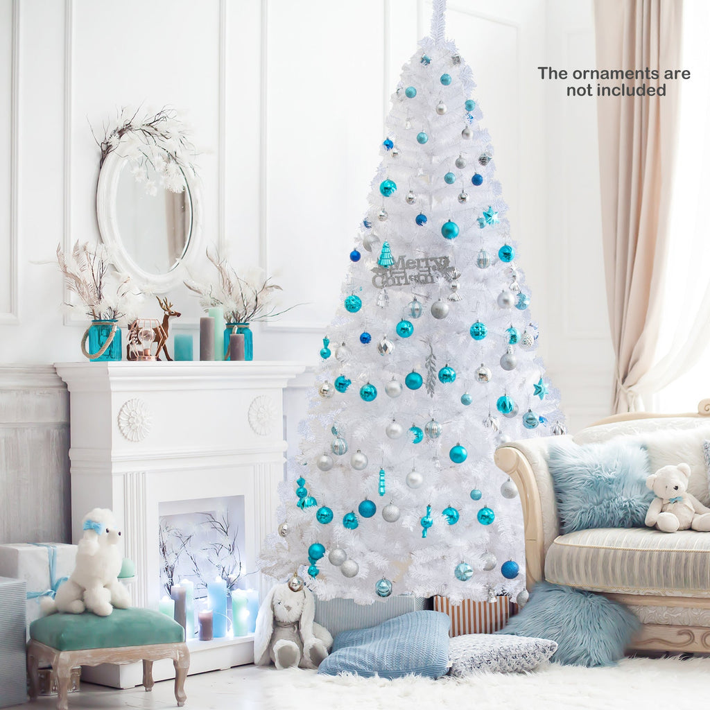 White artificial Christmas tree with blue ornaments and full snowy branches