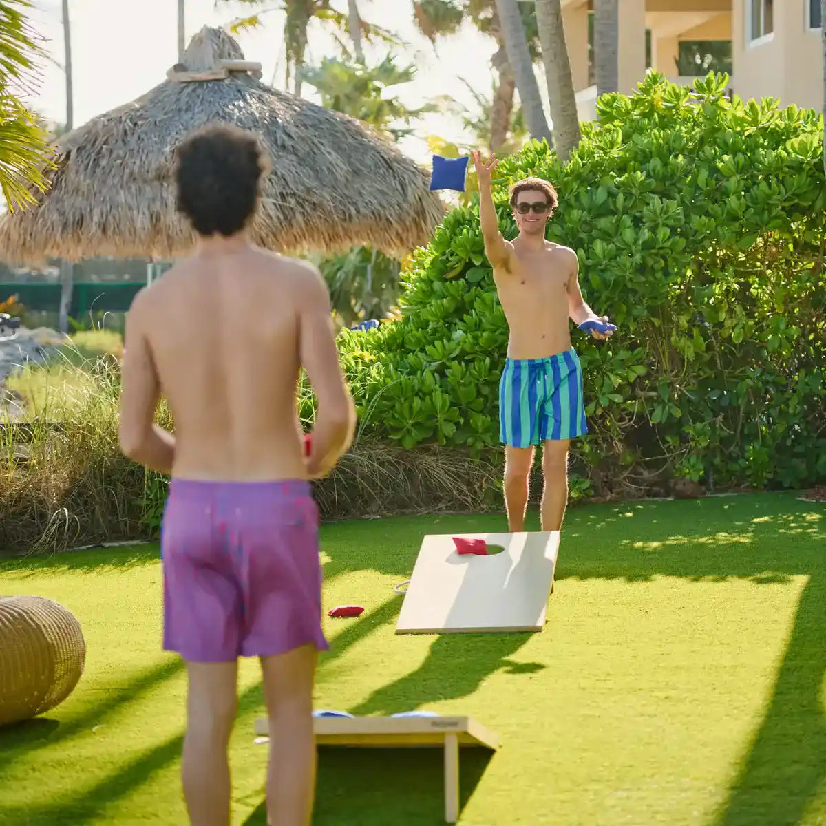 Blue and green striped swim trunks with drawstring waistband