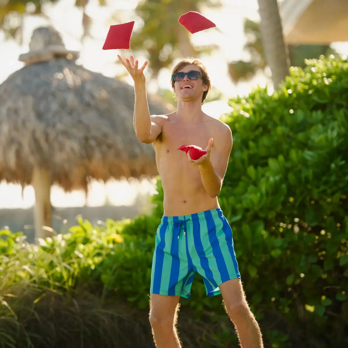 Blue and green striped swim trunks with elastic waist and drawstring