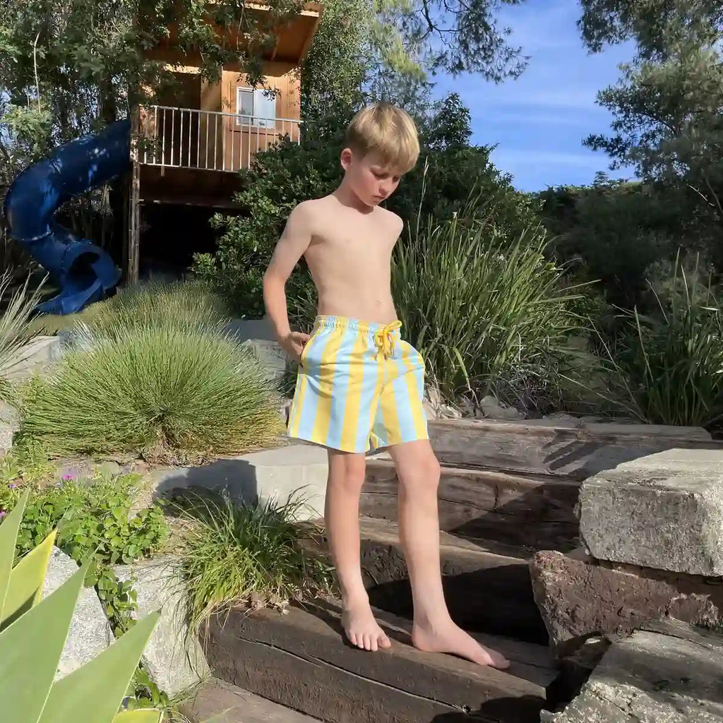 Boys swim trunks with light blue and yellow vertical stripes, pull-on elastic waistband