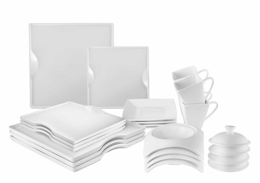 Assorted white porcelain dinnerware: square plates, mugs, and lidded pieces