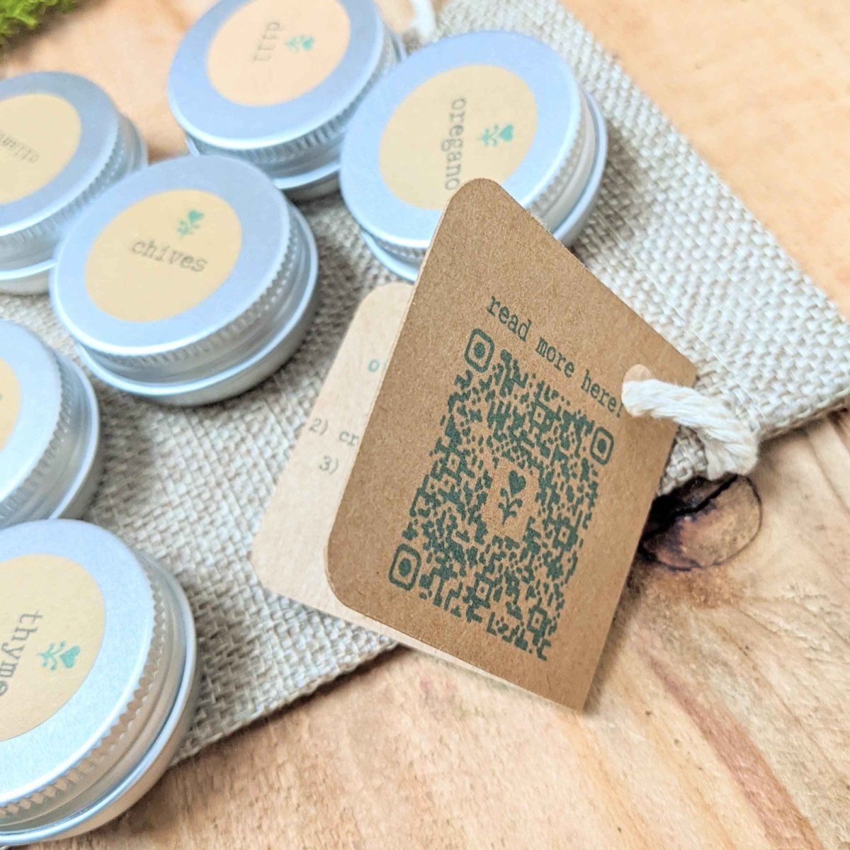 Herb seed collection seed tins with chives and thyme labels, with nearby tins