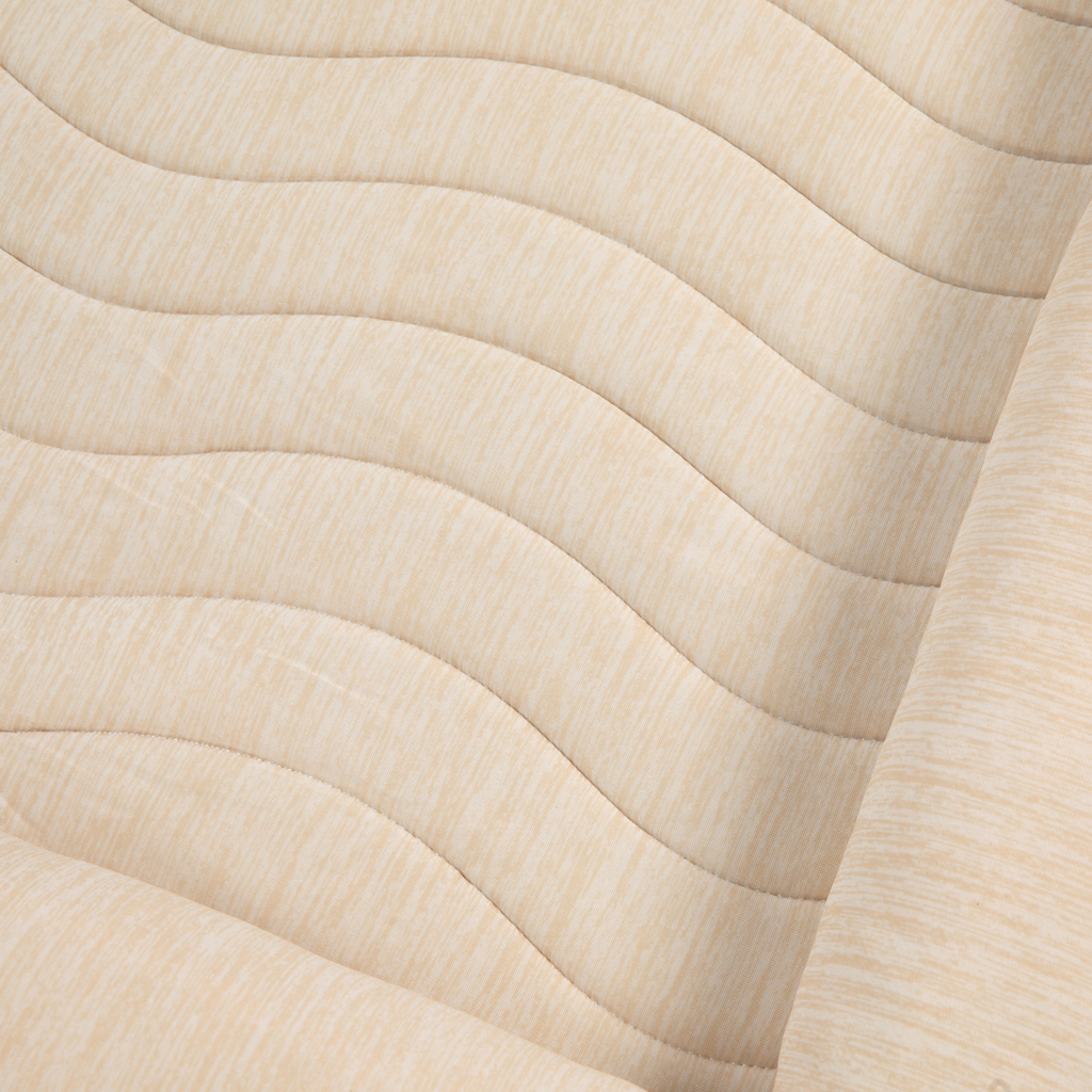 Close-up of arctic sand cooling bed cover fabric with quilted pattern and wave lines