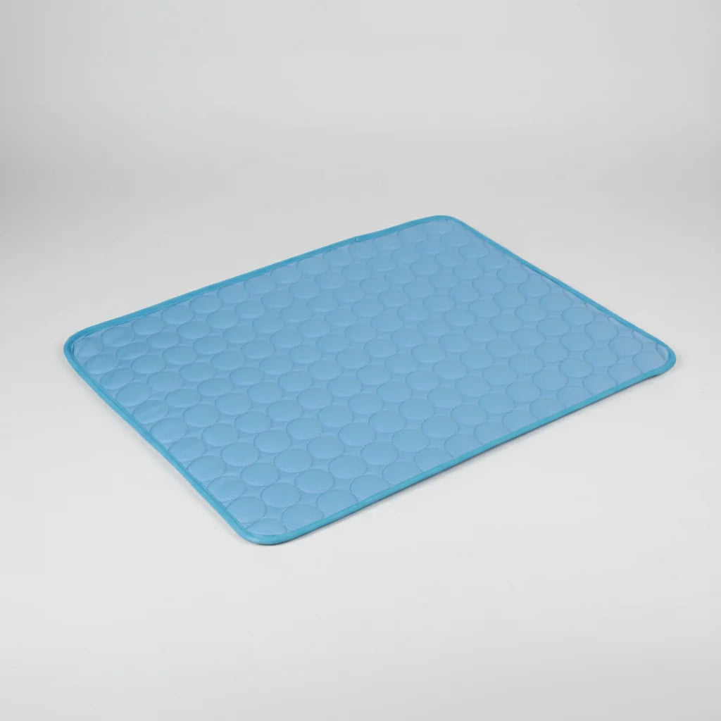 Blue cooling dog bed mat with raised pebble texture and rounded edges