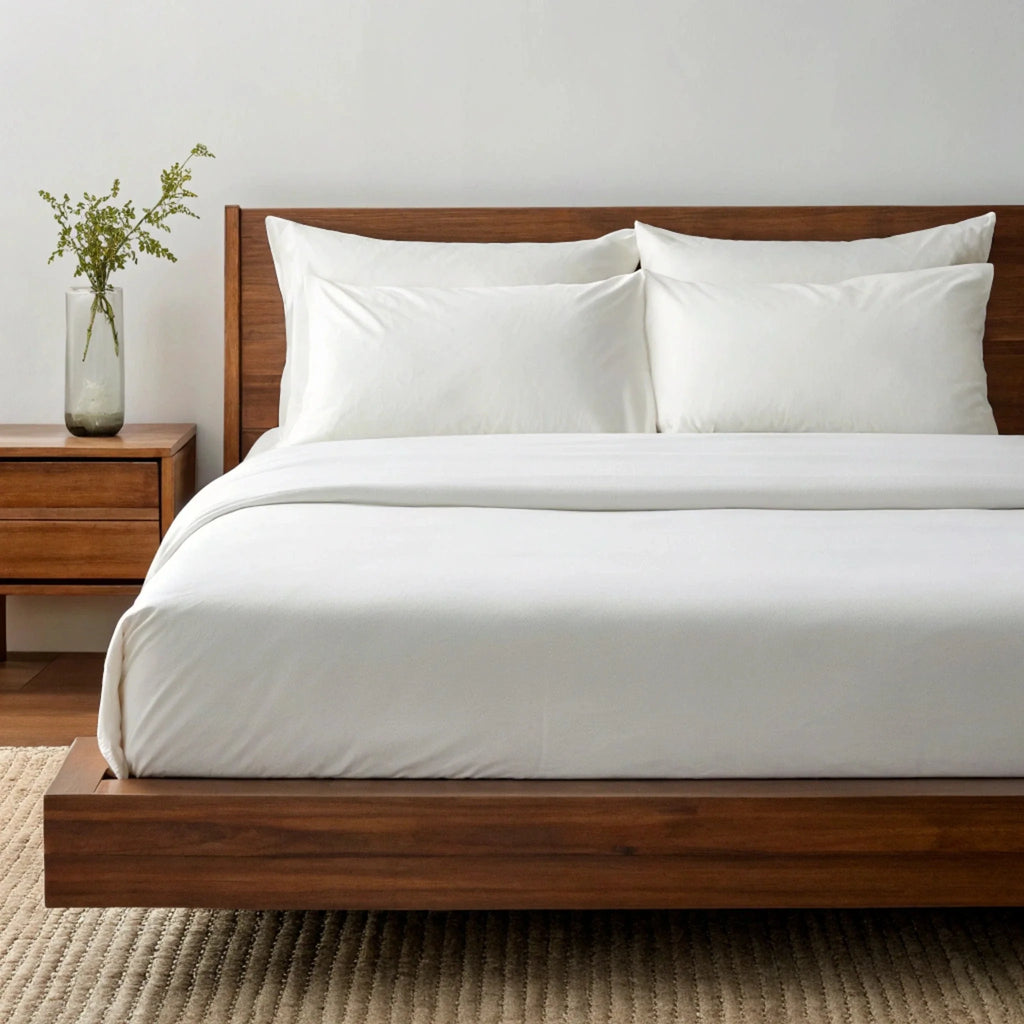 White bamboo sheet set with two pillowcases and a fitted sheet with clean edges.