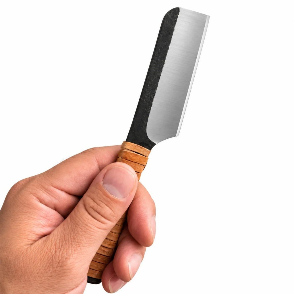 Kamisori knife held in hand; stainless blade with ribbed wood handle