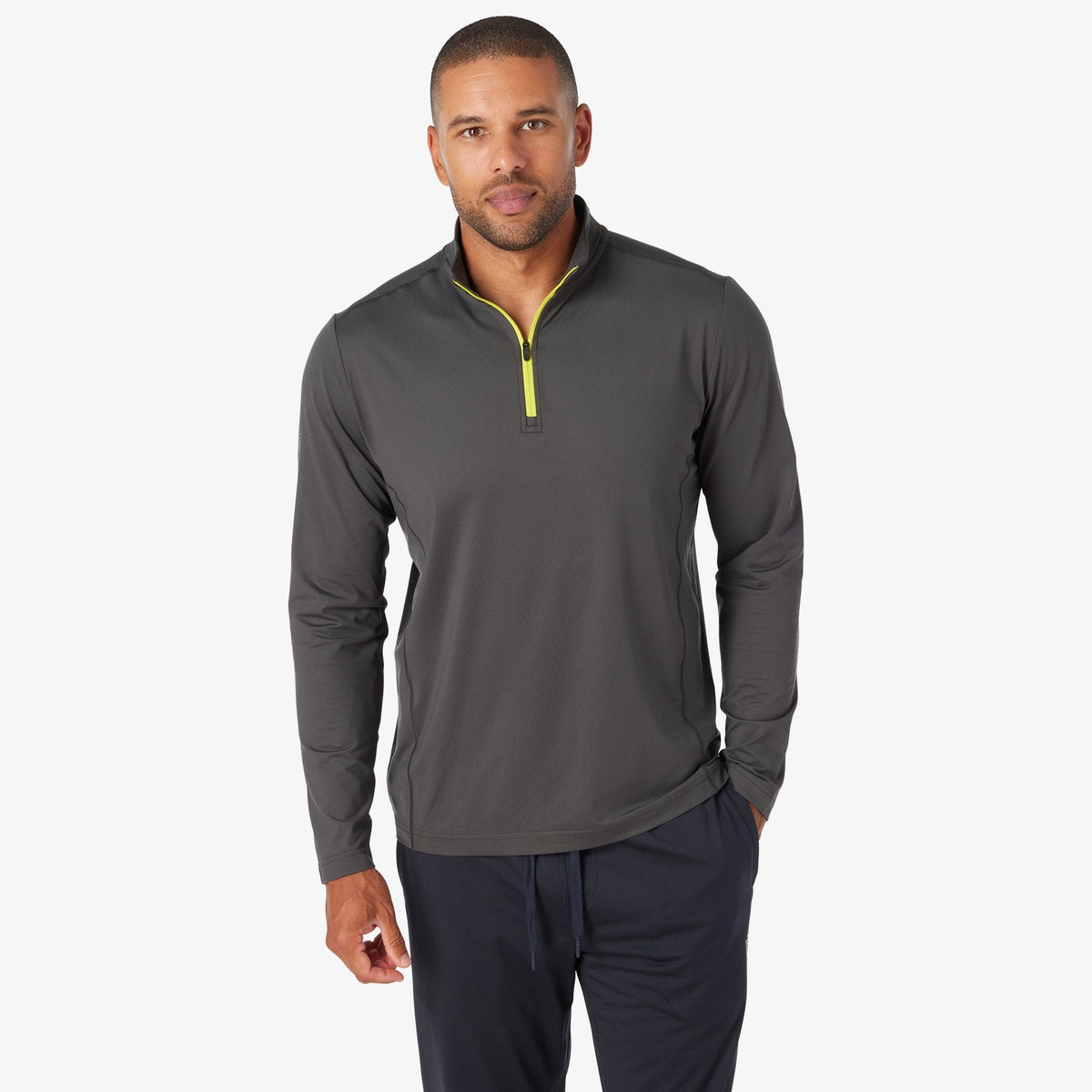 Charcoal quarter-zip tech pullover with neon yellow zip placket and long sleeves
