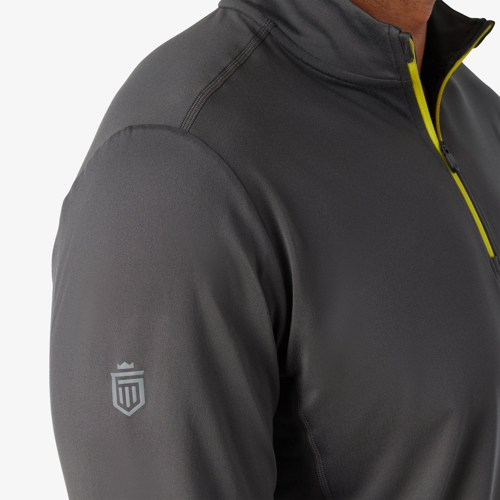 Charcoal quarter-zip with shield logo on sleeve and neon yellow zipper trim