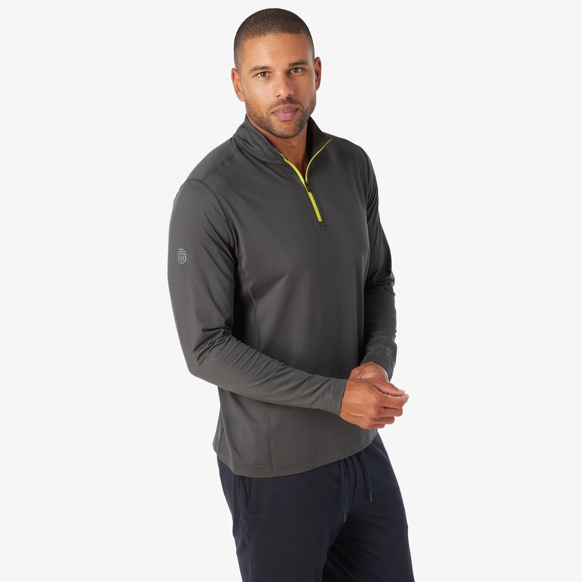Charcoal quarter-zip tech pullover with neon yellow zipper and small left-sleeve logo