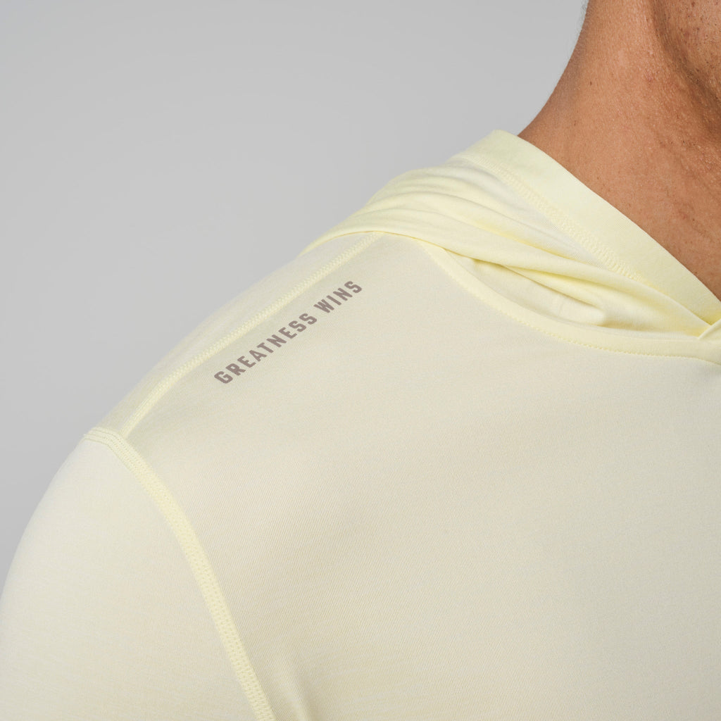 Light yellow hoodie back with 'GREATNESS WINS' graphic near shoulder