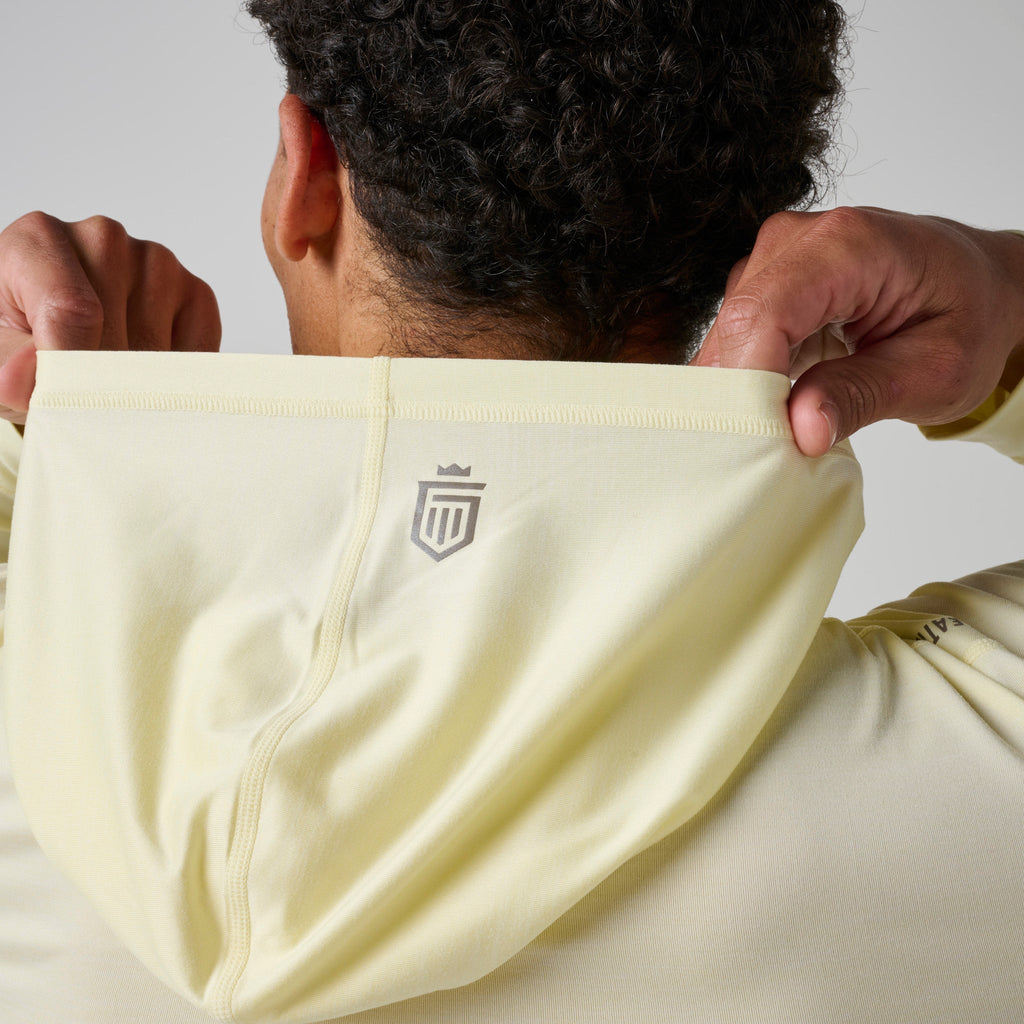 Back view of light yellow hoodie with small chest logo patch