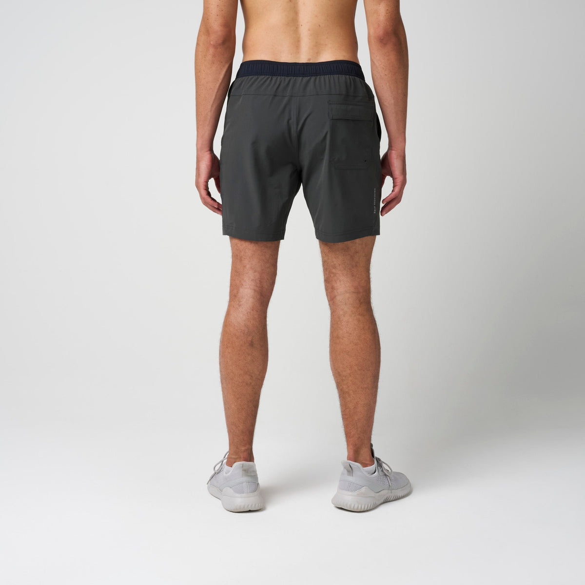 Dark training shorts with elastic waistband and relaxed knee-length cut