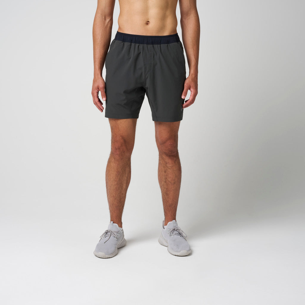 Dark training shorts on model front view with elastic waistband and relaxed fit