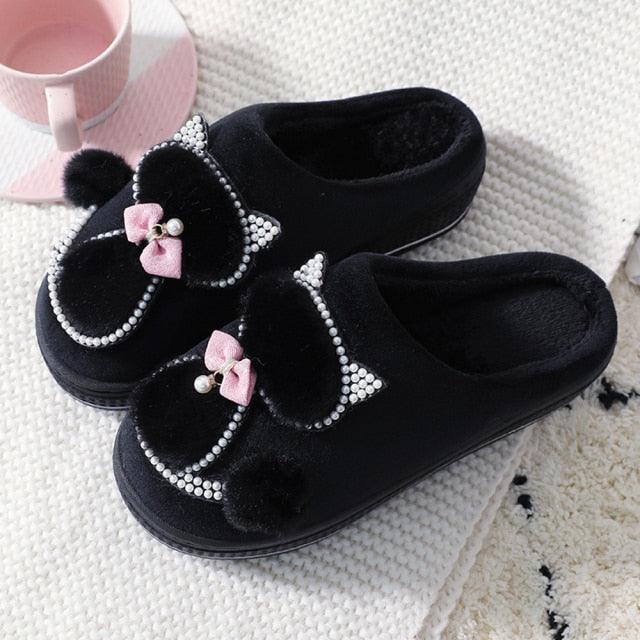 Black plush cotton slip-on slippers with bow, rhinestone trim, and pom pom detailing