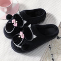 Black plush cotton slip-on slippers with bow, rhinestone trim, and pom pom detailing