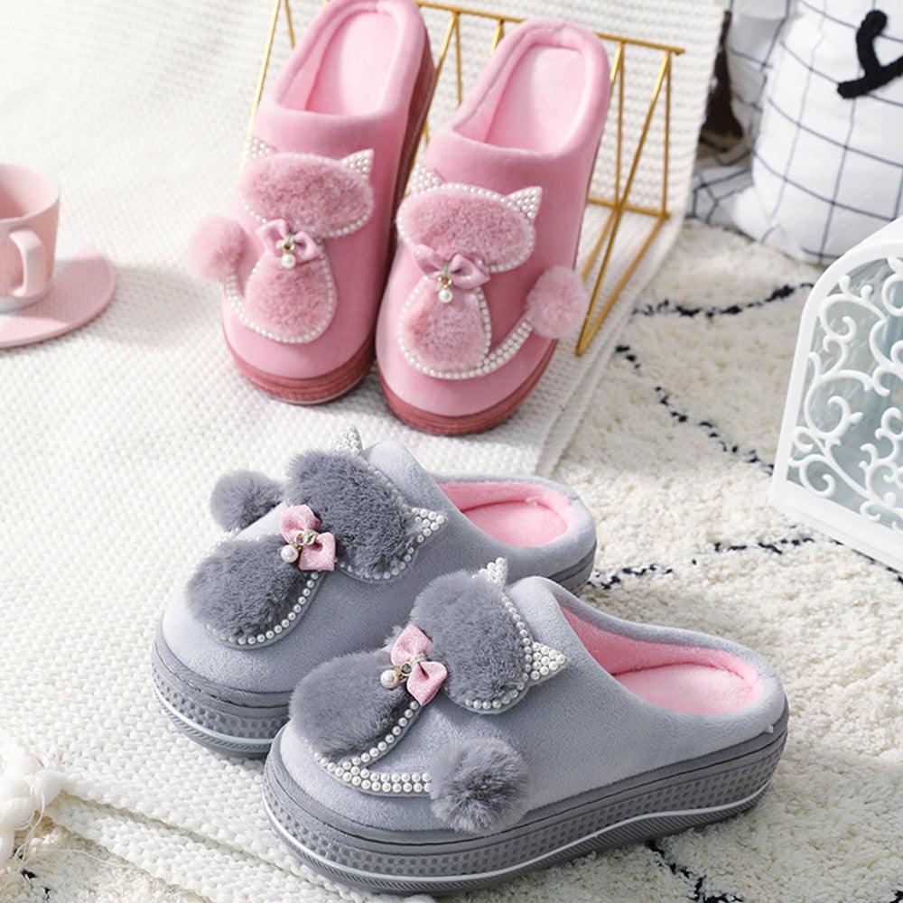 Light gray and pink fuzzy indoor slippers with bow and rhinestone trim