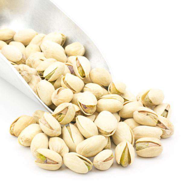 Dry roasted salted pistachios in shells, pale green nuts partially opened