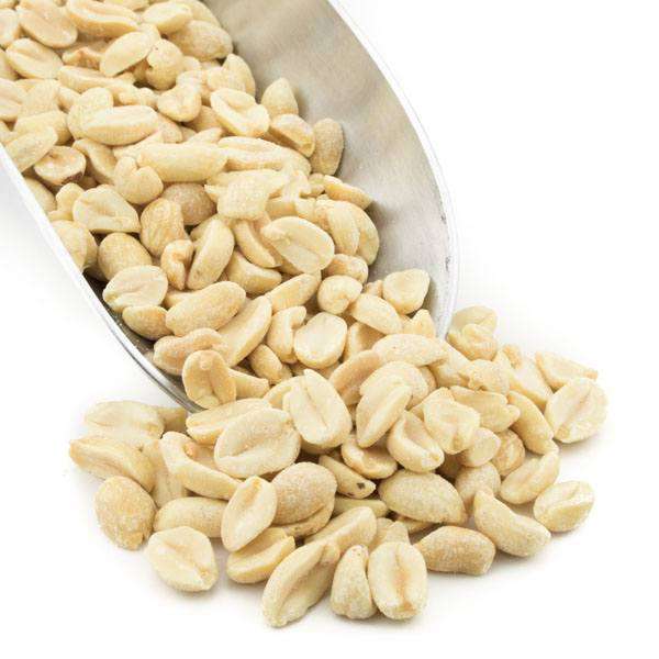 Dry-roasted peanut halves in a metal scoop, light golden color